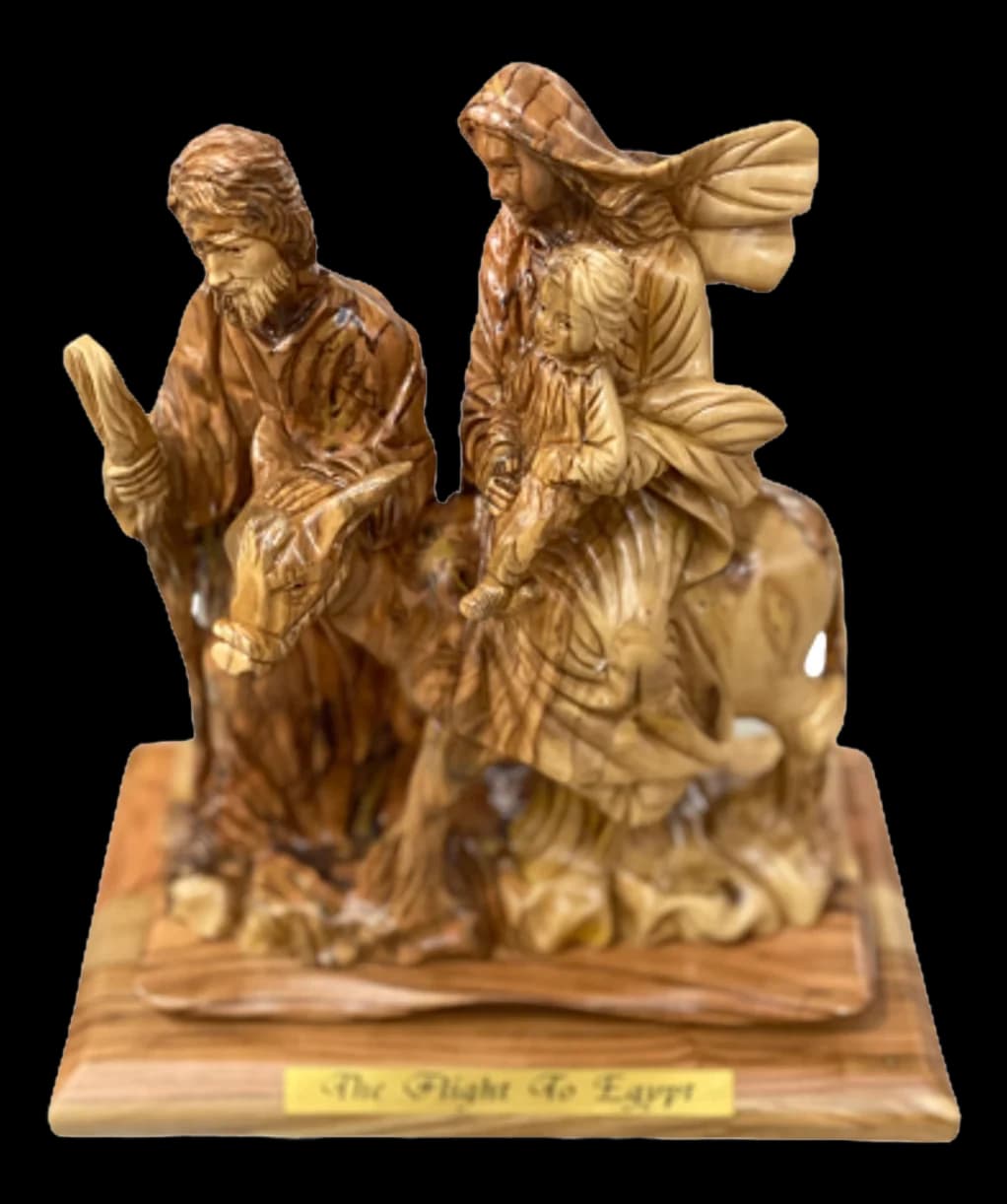 Olive wood carving of Joseph leading a donkey carrying Mary and the infant Jesus