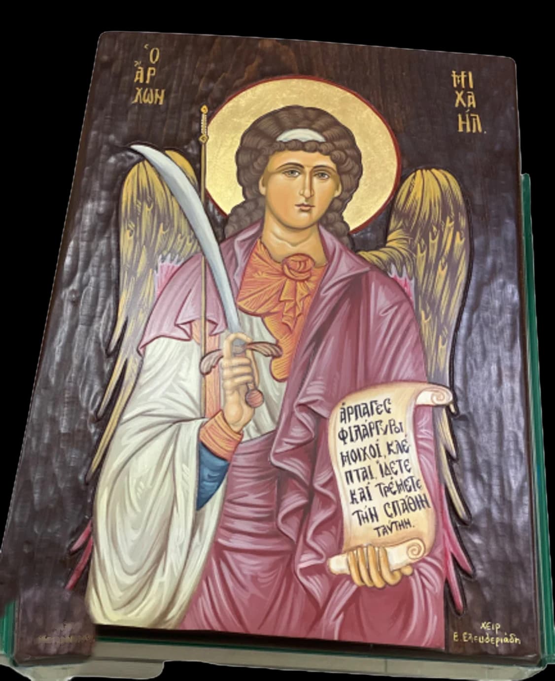 Hand-painted icon of the Archangel Michael holding a sword and a scroll